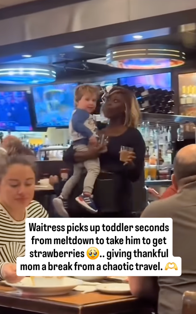 Waitress holds a toddler, comforting him while a mother looks relieved. Text describes waitress taking child for strawberries to give mom a break