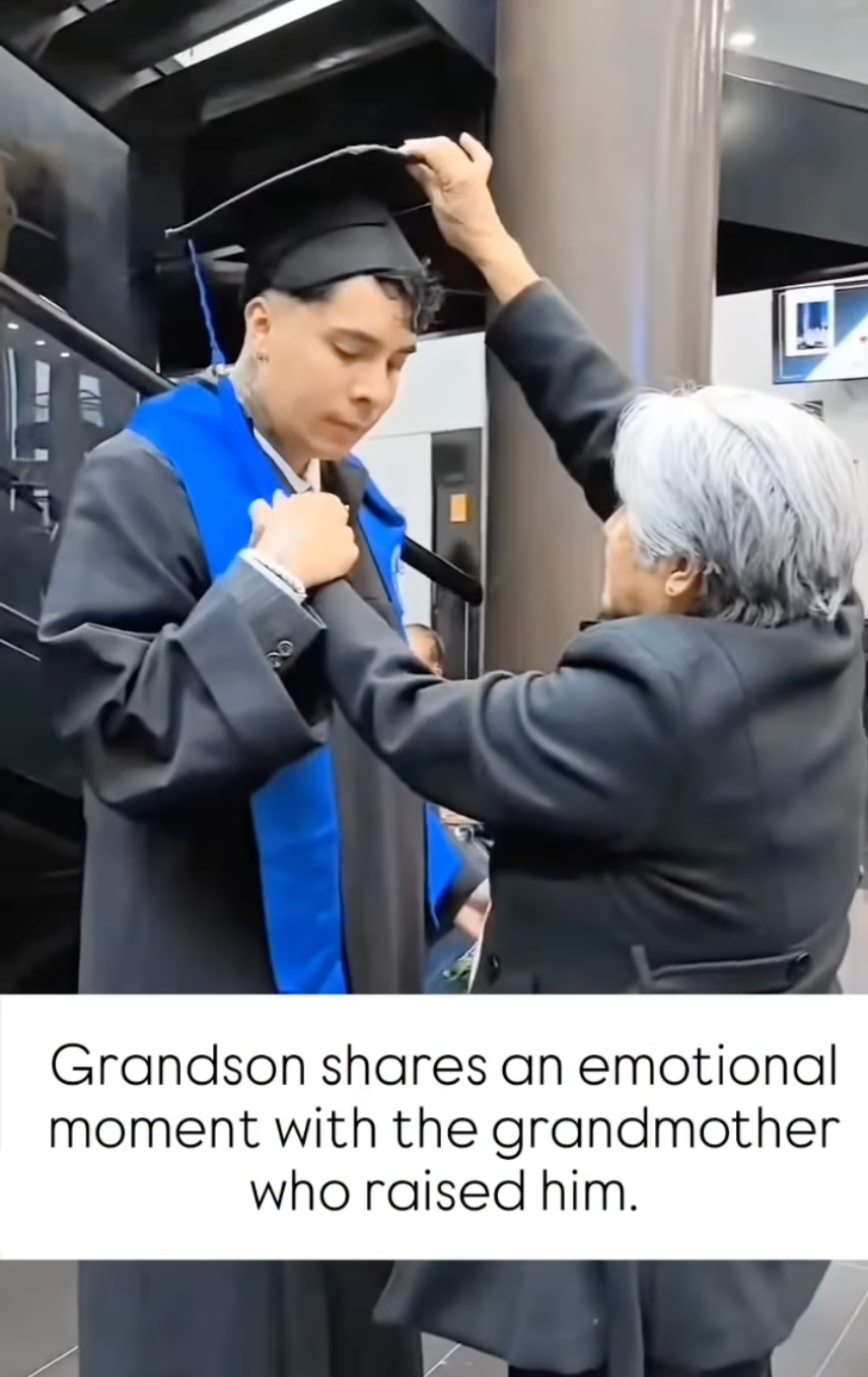 Grandmother adjusts grandson’s cap at graduation ceremony; both share a tender, emotional moment. Caption reads:
