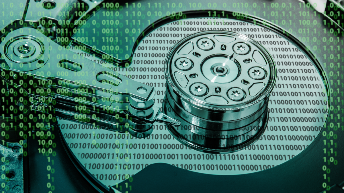 An illustration of a hard drive with binary zeros and ones dotted around the foreground and background.