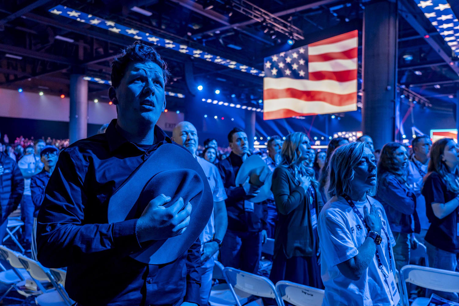 Attendees sing the national anthem. (Mark Peterson for NBC News)