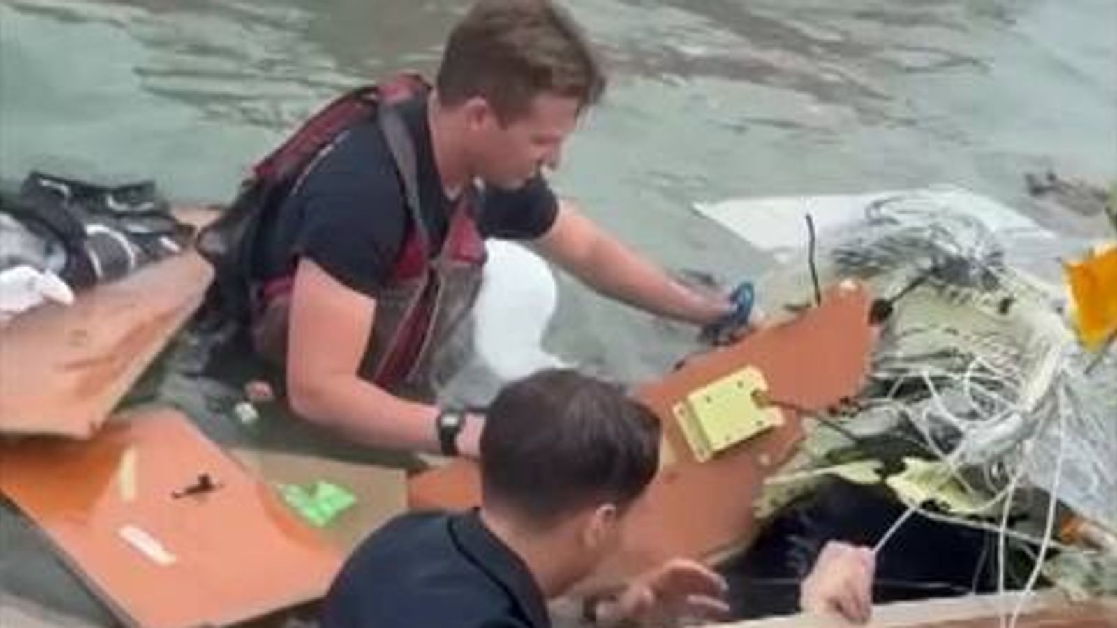 Rescuers work to free survivors from plane wreckage