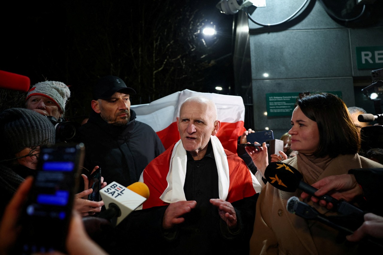 Nobel laureate Ales Bialiatski, standing next to Belarusian opposition leader Sviatlana Tsikhanouskaya, speaks after his release outside the U.S. Embassy in Vilnius, Lithuania, this month.