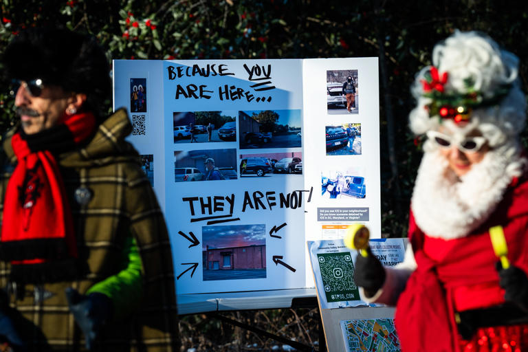 TAKOMA PARK, MD ‐ December 15: Matthew Grace, 57, left, sings with Locals and members of the St. Camillus Intercultural Choir in a parking lot that is typically used by ICE as a staging location in Takoma Park, MD on Monday December 15, 2025. Community organizers are gathering and scheduling events in the parking lot for the upcoming weeks to reclaim the space from ICE agents. (Photo by Demetrius Freeman/The Washington Post)