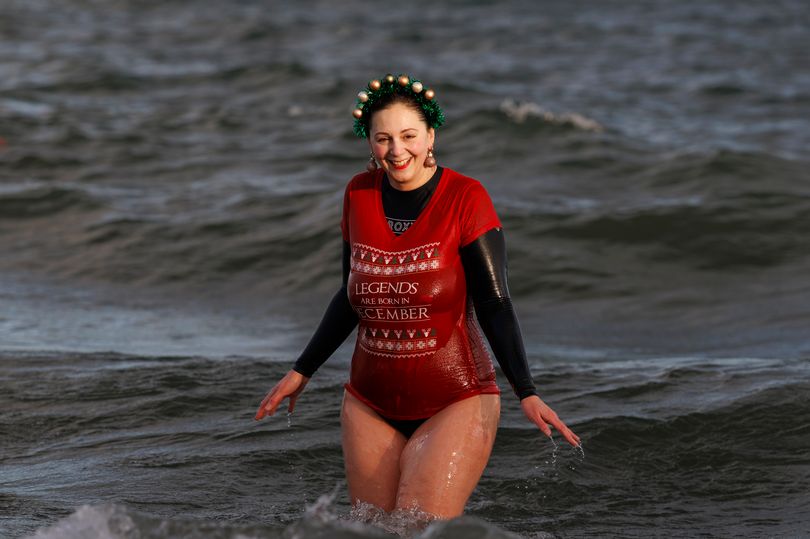 Hundreds brave the cold to make a splash for charity in Christmas Eve ...