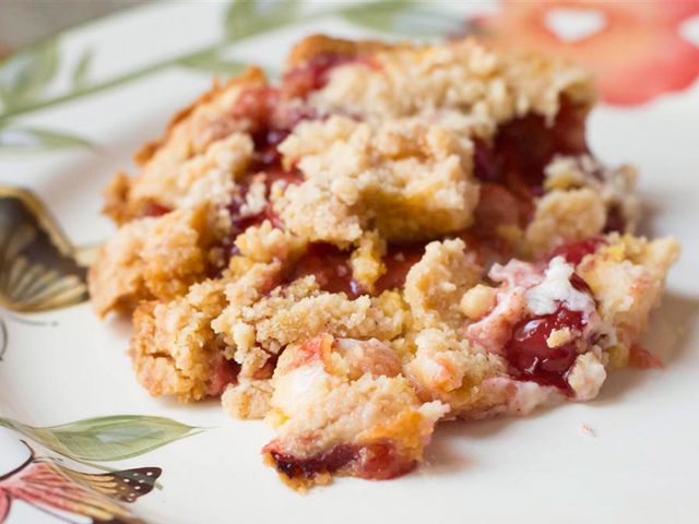 close up view of Cherry Cream Cheese Dump Cake on a floral plate