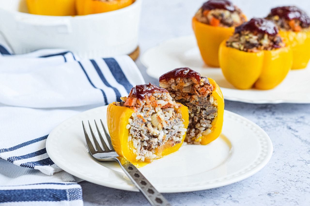 Stuffed bell pepper sliced half on a plate to show the filling.