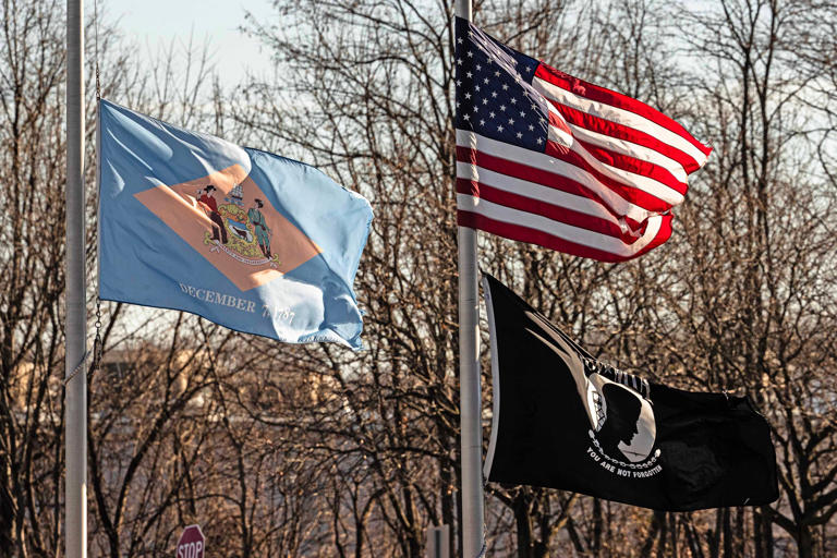 Why are the flags at half-staff today in Delaware and how long lowered