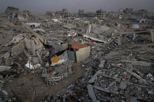 A family tent stands among the ruins of homes in the Al-Zaytoun neighborhood of Gaza City, late November (AP)
