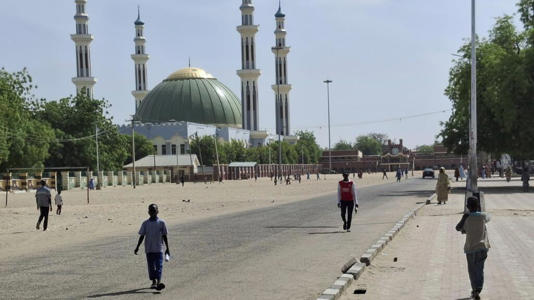 File photo: People walk past a mosque in Maiduguri, Nigeria, Friday, March 14, 2025.