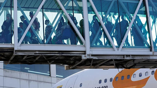 Venezuelan migrants deported from the United States deplane at Simon Bolivar International