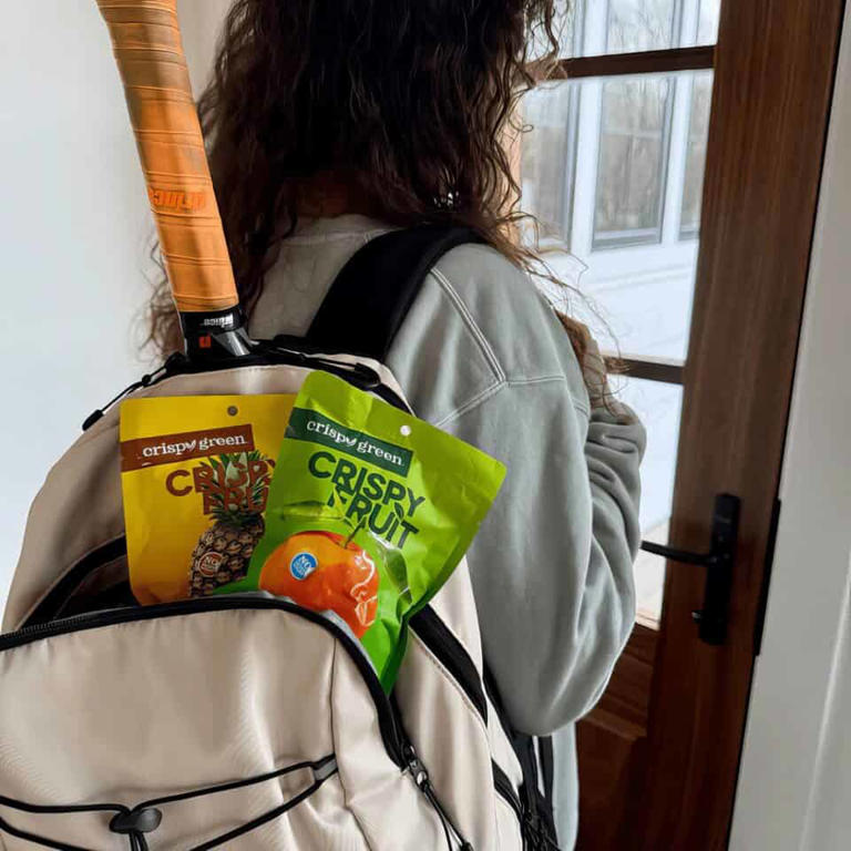 Compact backpack with crispy green fruit snacks and pineapple chips.