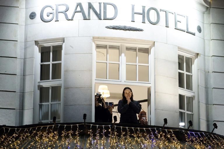 Machado greets supporters from a balcony in Oslo.