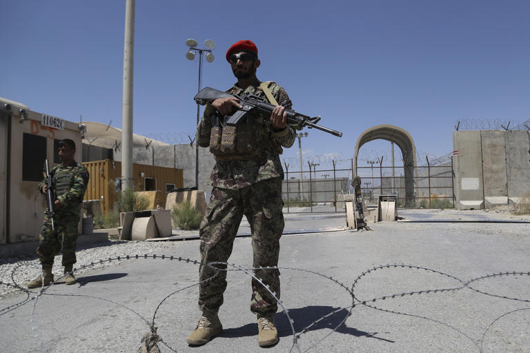 Afghan soldiers stand guard at Bagram air base on July 2, 2021, after U.S. troops pulled out.