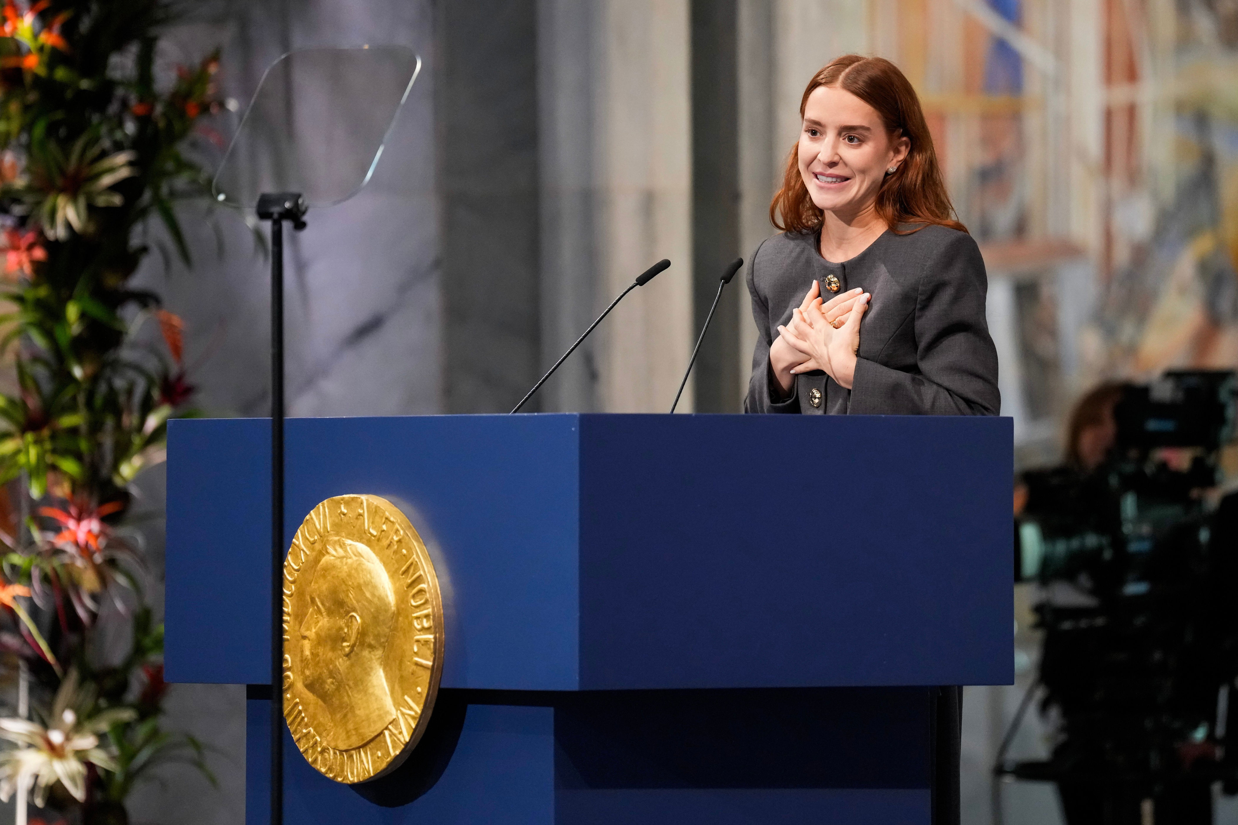Machado’s daughter, Ana Corina Sosa Machado collected the award on her behalf (AP)