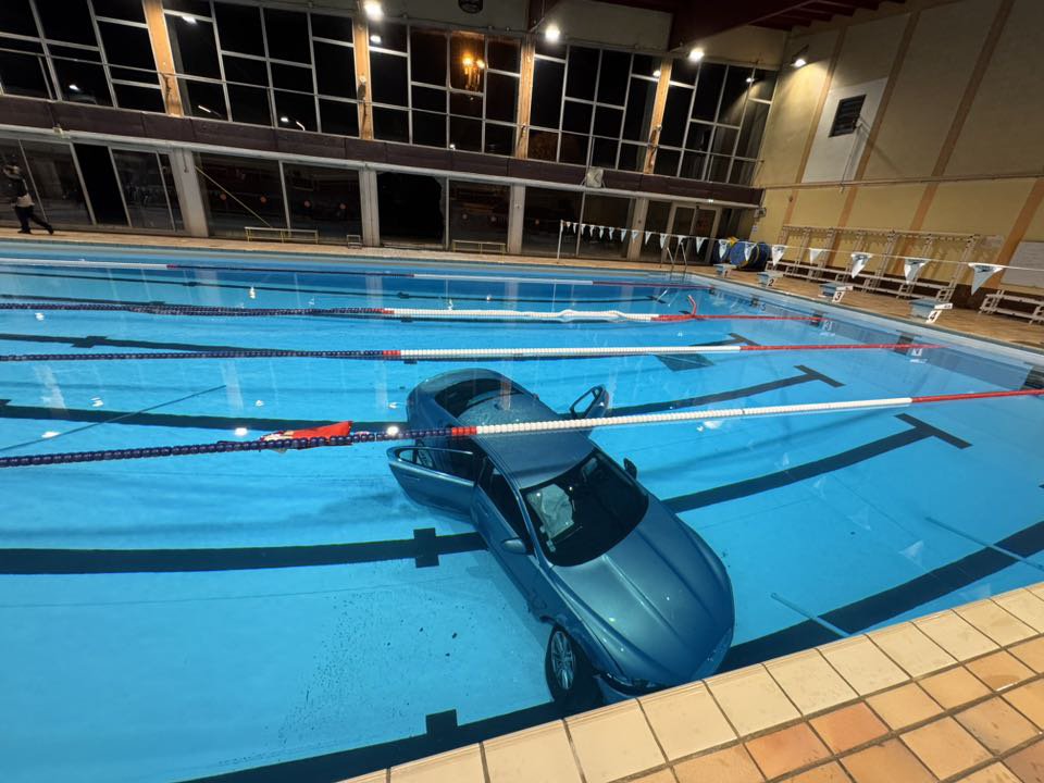 Mum crashes into swimming pool with daughter in car