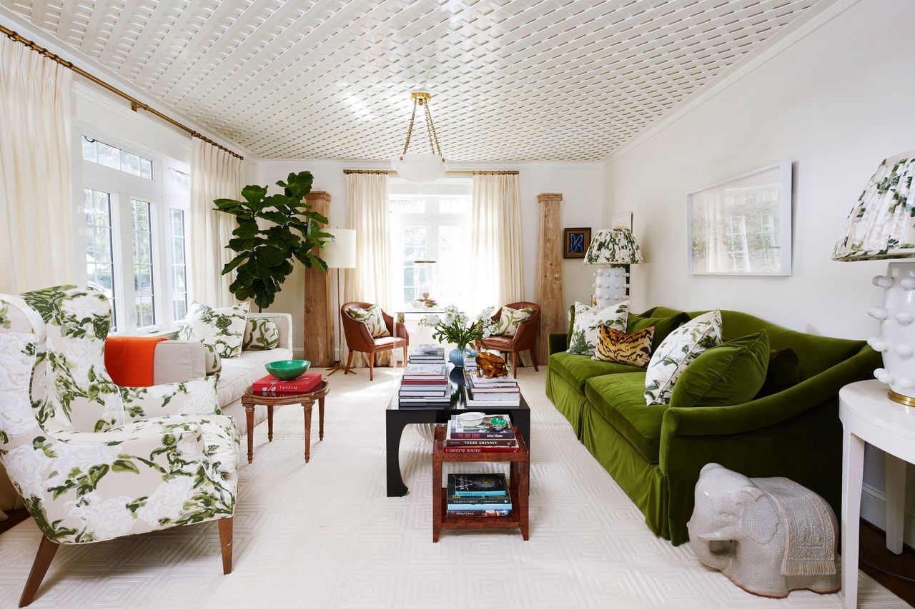 White living room with lattice detailed ceiling and green velvet sofa