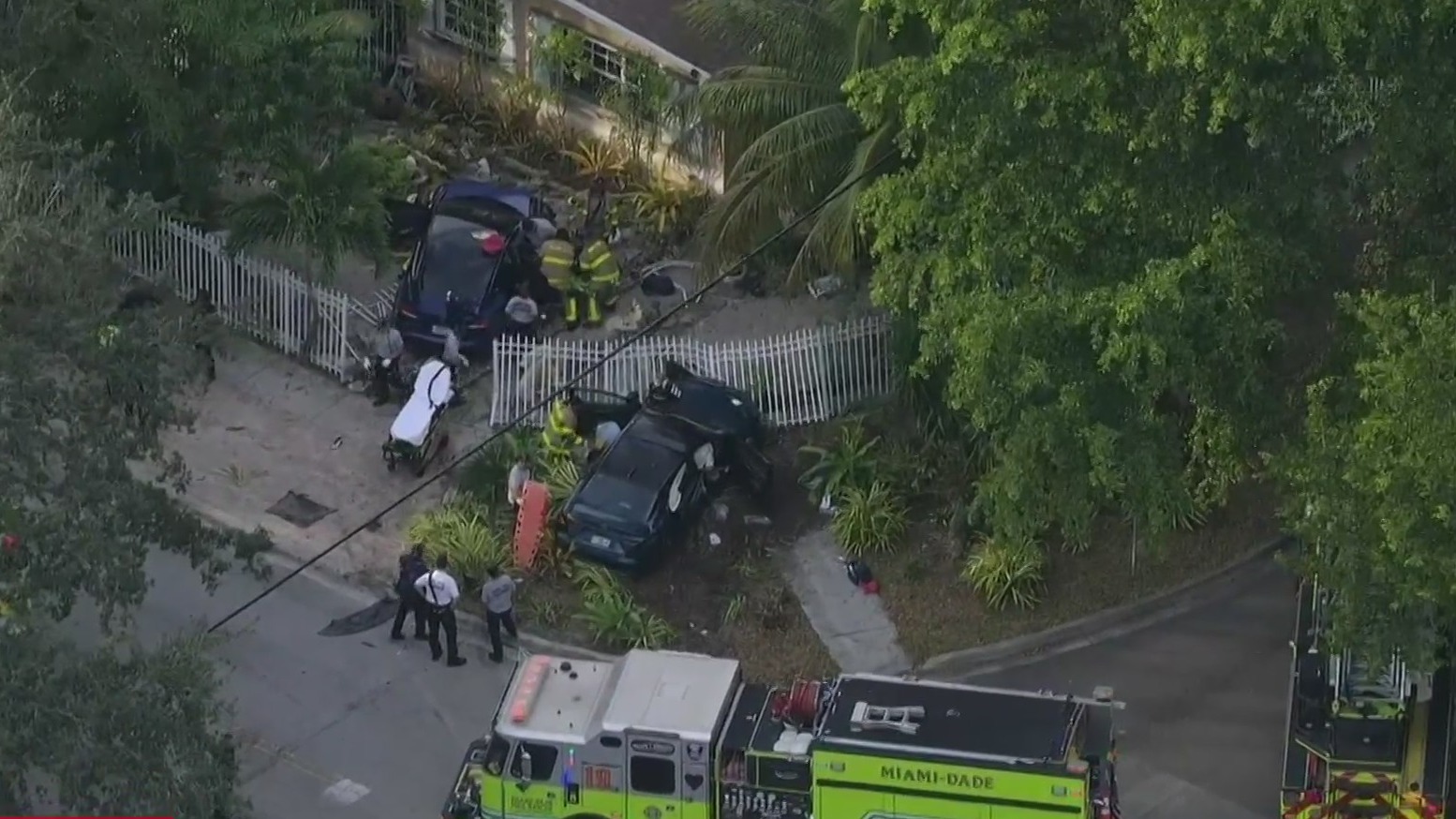 Four hospitalized after two-car crash sends vehicles into North Miami yard