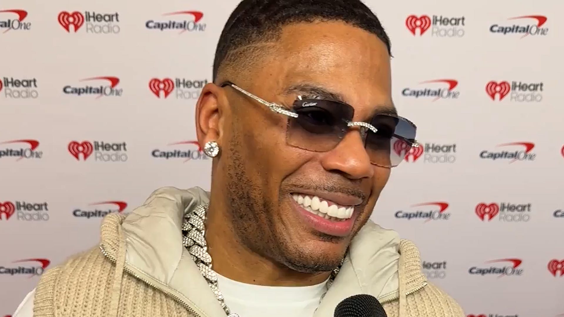 Nelly reflects on fatherhood and his music career at Jingle Ball red carpet