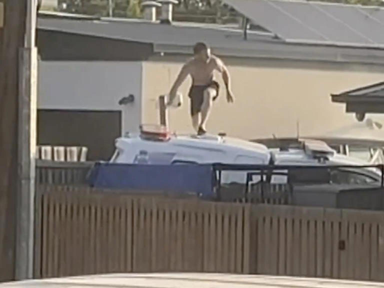 Wild moment shirtless man rams cop car