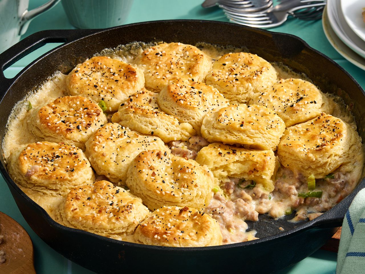 Skillet pot pie topped with biscuits containing gravy and filling