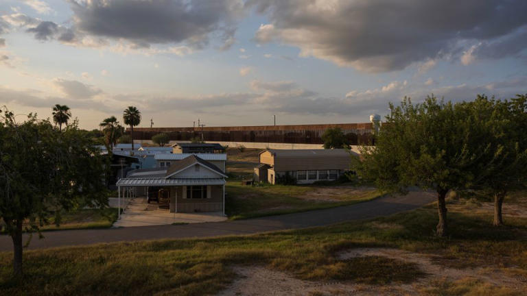 The border wall is seen near a community along the Rio Grande in Mission, Texas, on August 9. - Tom Brenner for The Washington Post/Getty Images/File