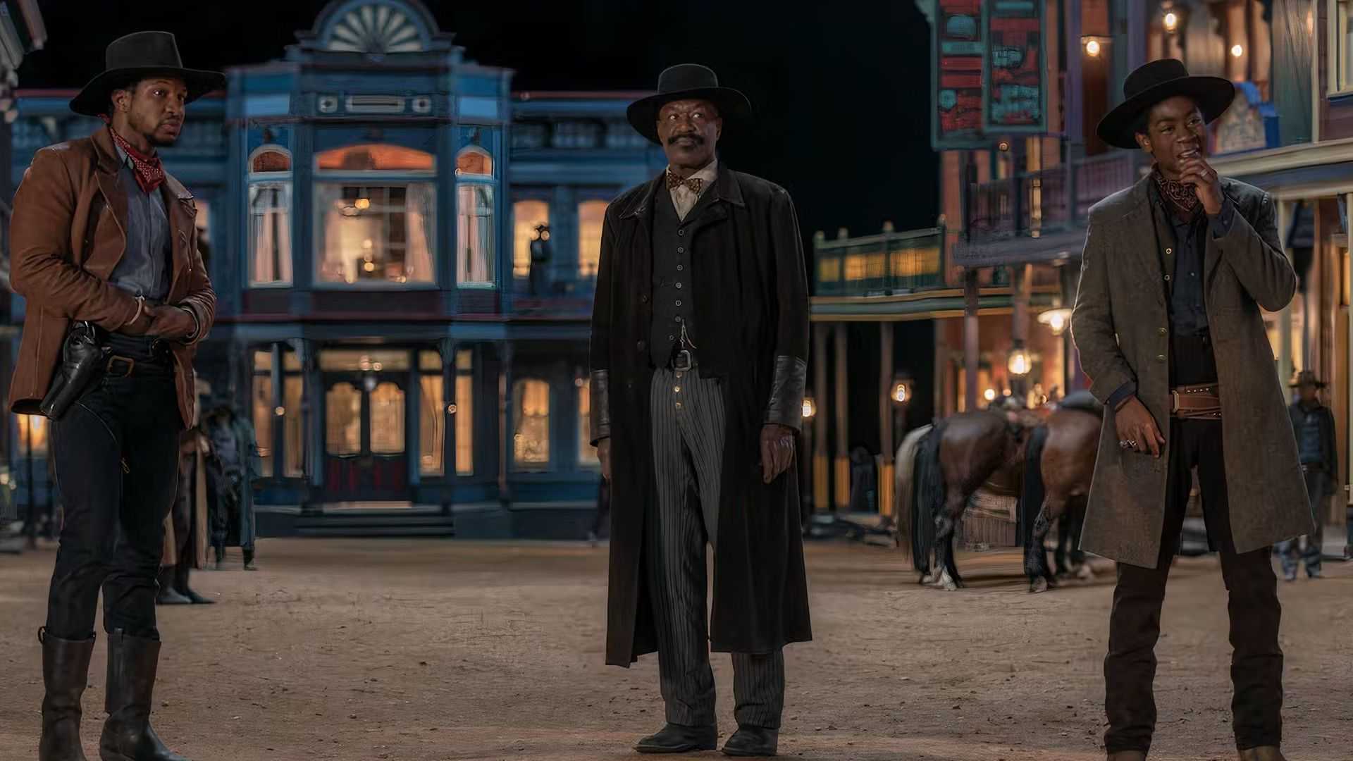 Bass Reeves stands with Nat Love and Beckwourth on a dusty street in The Harder They Fall