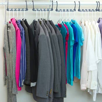 A neatly organized closet with the hangers set in a horizontal position showing how it leaves space between clothes