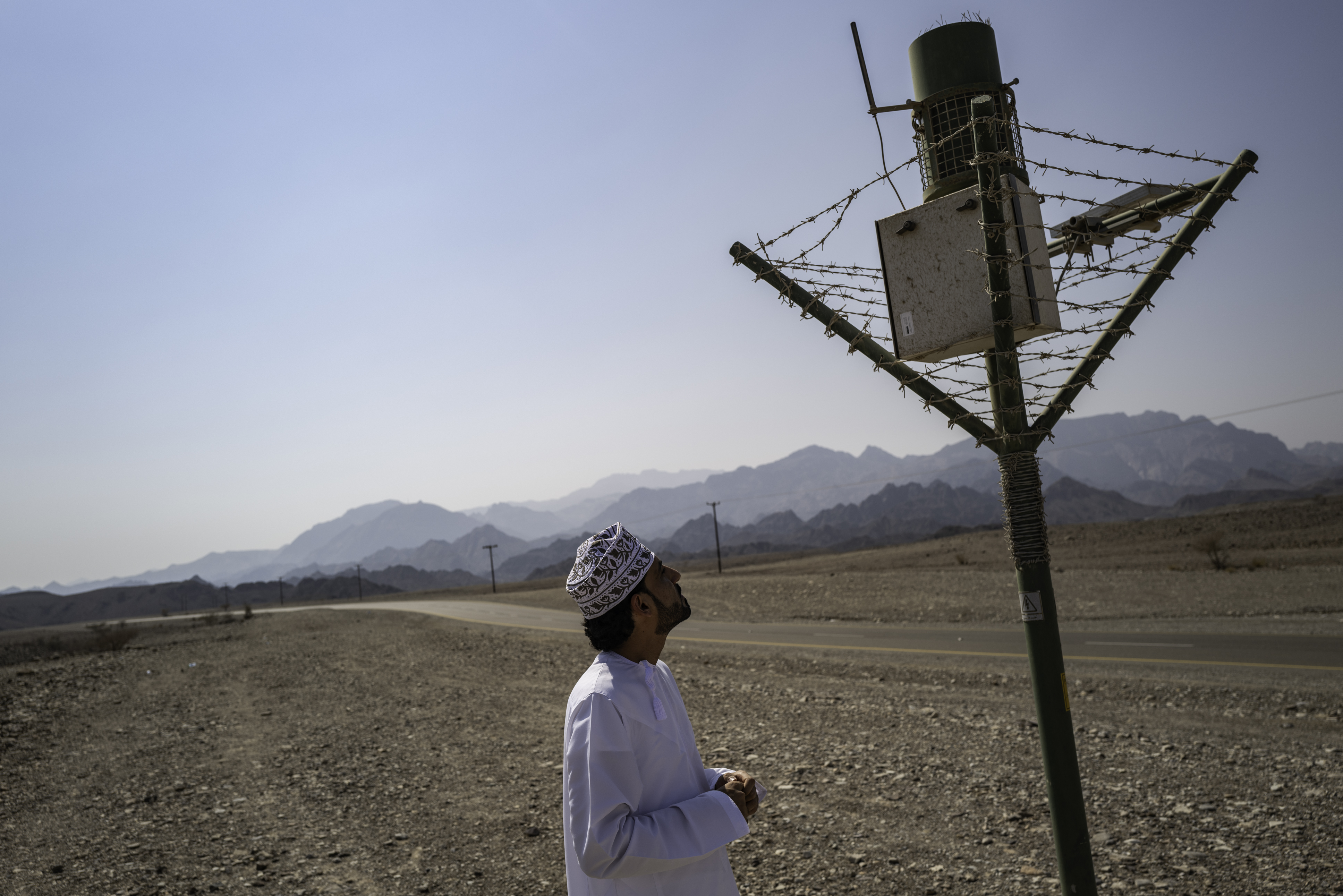 Badar al-Jahwari, graduate student at Sultan Qaboos University, at a rainfall collection station along Wadi al-Hawasinah.