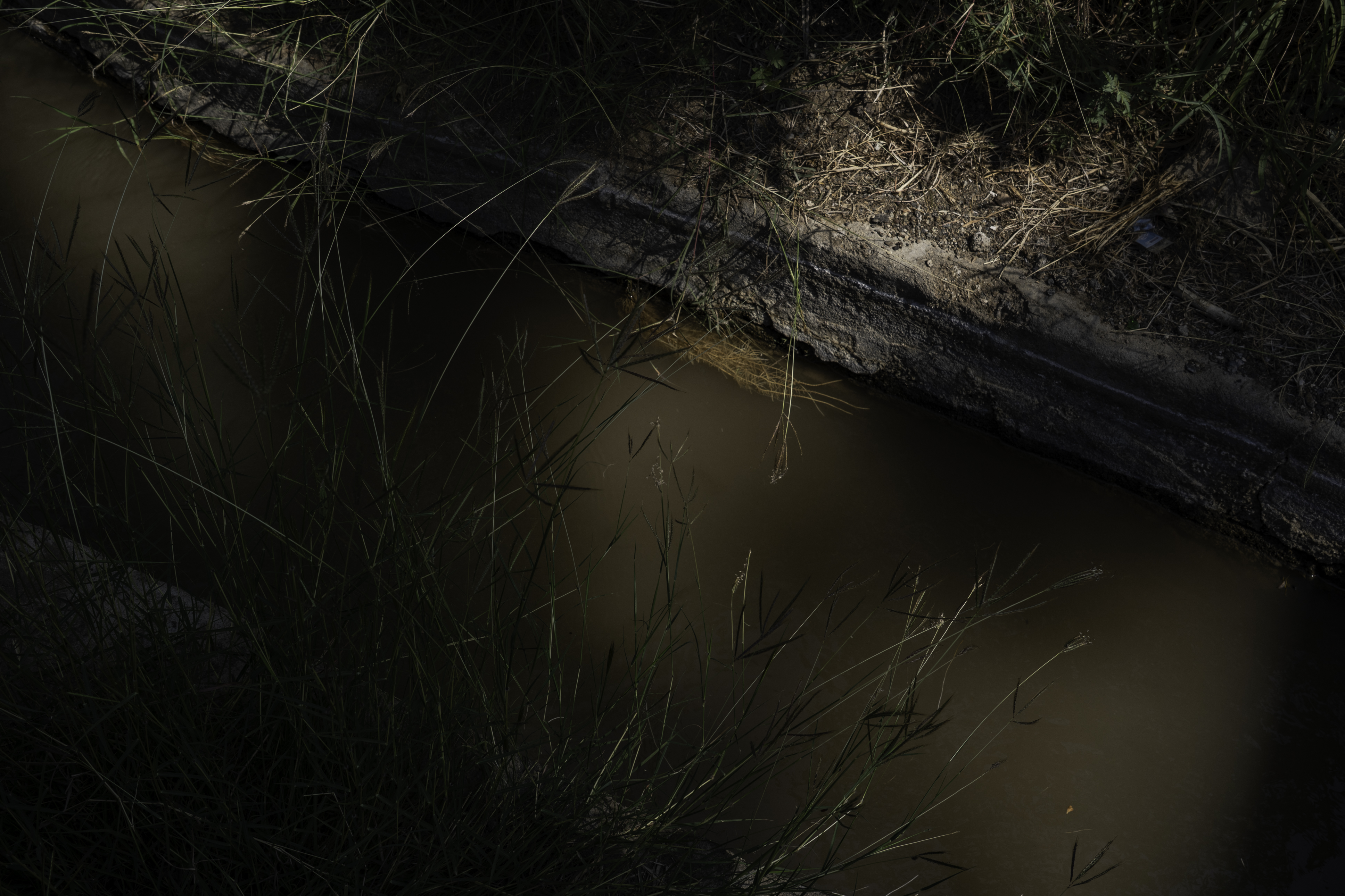 Underground water flows toward farms to be used to water trees in Samad al-Shan.