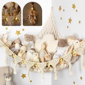 Cream macrame hammock with stuffed animals and surrounded by gold stars on the wall and star shaped lights