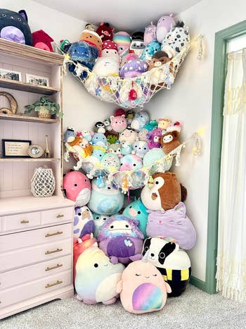 Corner of room with two hammocks hanging, each loaded with squishmallows