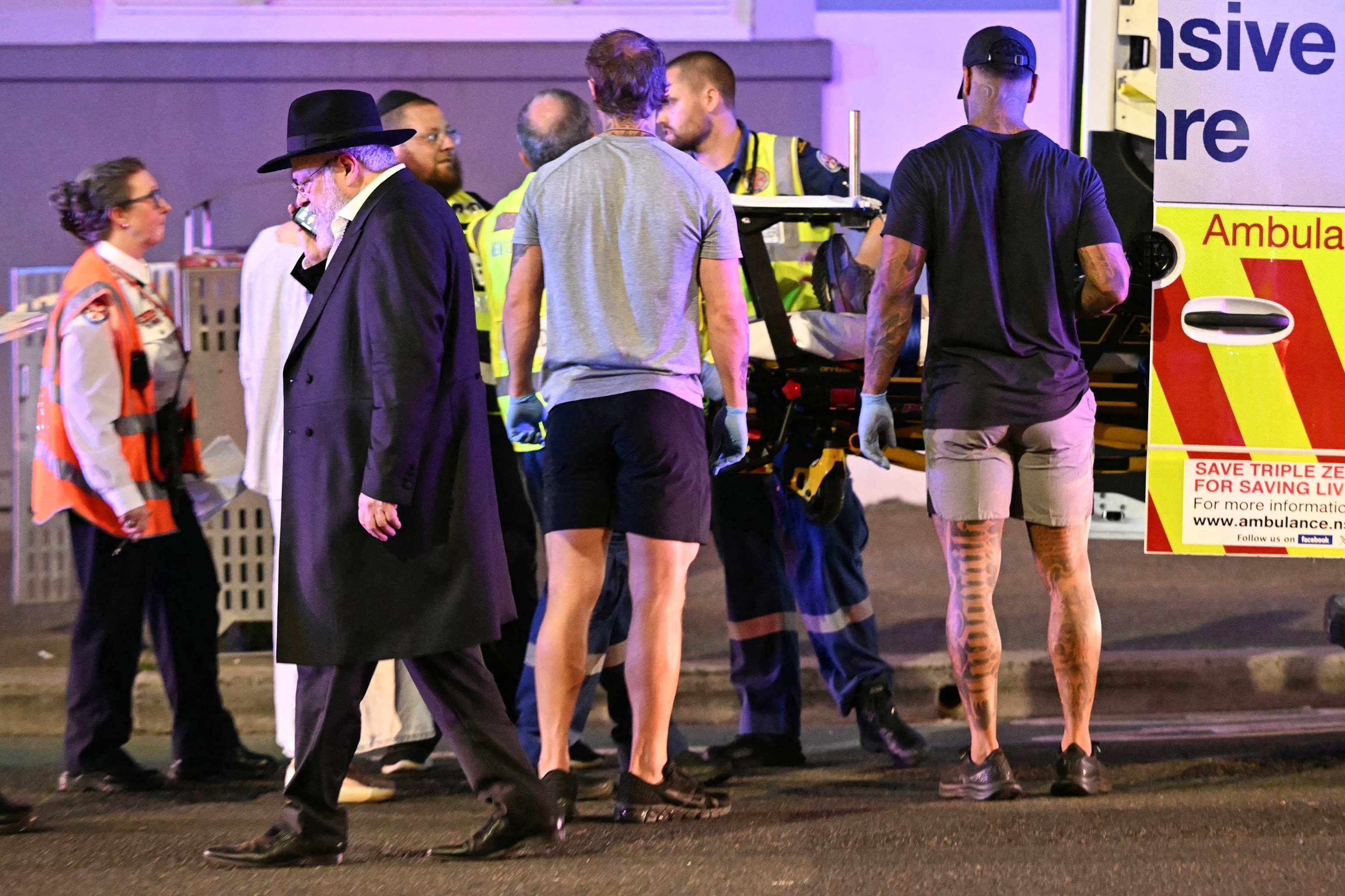 Saeed Khan/AFP via Getty Images - PHOTO: Health workers put a patient into an ambulance after a shooting incident at Bondi Beach in Sydney on Dec. 14, 2025.