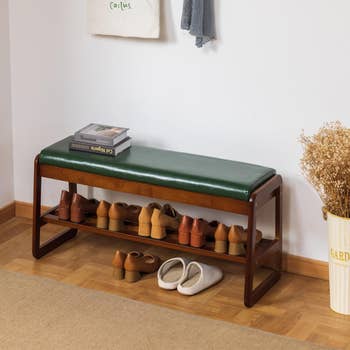 wooden bench with cushion top and a shelf beneath the seat to store shoes