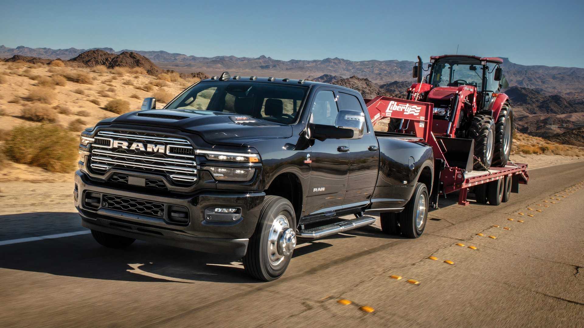 2025 Ram 3500 Heavy Duty Laramie towing a tractor on a trailer