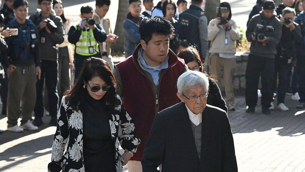 Jimmy Lai's wife, Teresa, their son Shun Yan and Cardinal Joseph Zen arrive at court