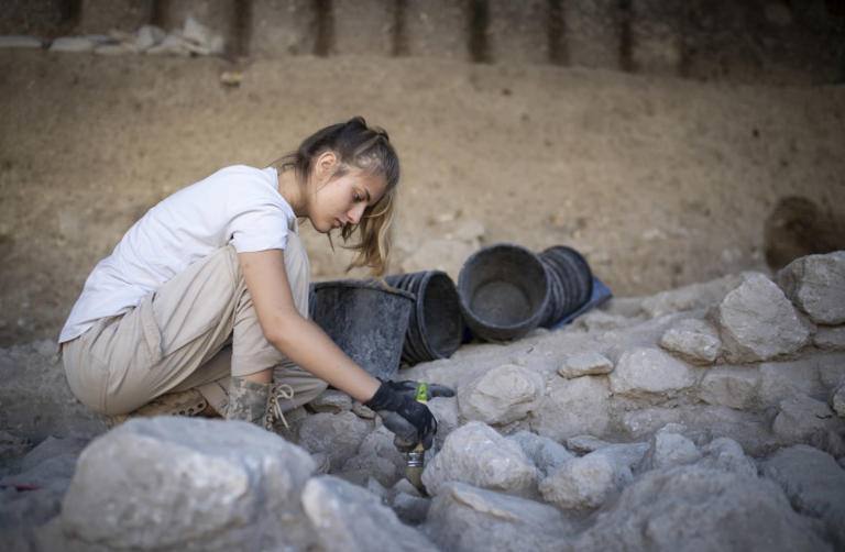 Valeria Fenik works at a digging site in the Givati Parking Lot excavation grounds, at the City of David National Park, on July 22, 2019. The most recent digging site currently under work is attributed to the Muslim, Byzantine, and early Roman periods. (credit: HADAS PARUSH/FLASH90)