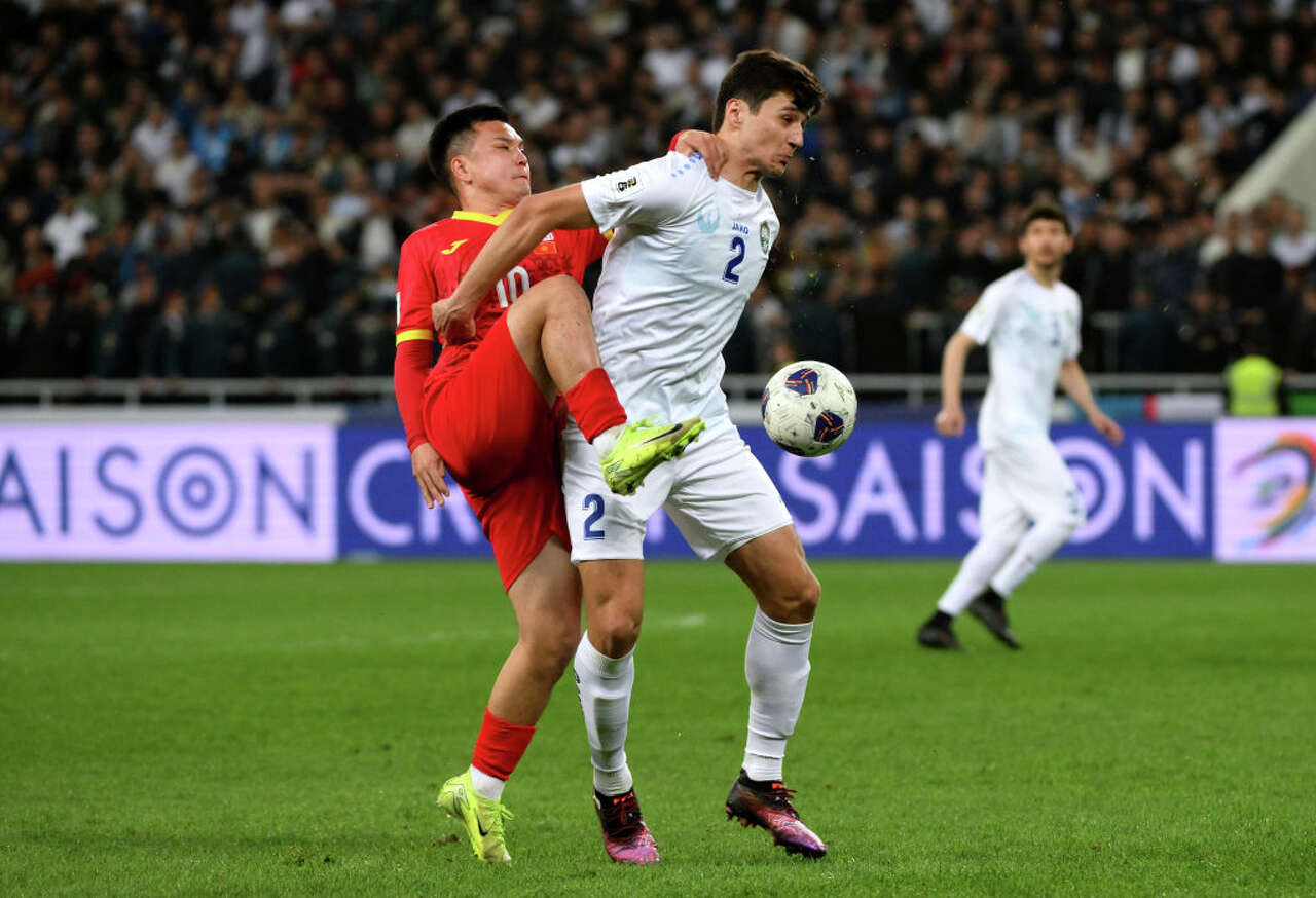 Abdukodir Khusanov of Uzbekistan is challenged by Gulzhigit Alykulov of Kyrgyz Republic during the AFC Qualifiers Group A match between Uzbekistan and Kyrgyz Republic at Milliy Stadium on March 20, 2025 in Tashkent, Uzbekistan. (Anvar Ilyasov/Getty Images)