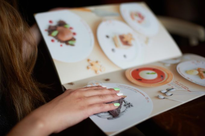 Menu card in woman’s hand