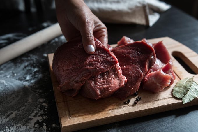 Women’s hands cut beef for cooking dumplings