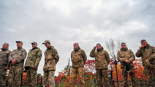 Service members bid farewell during a funeral ceremony to Ukrainian soldier Oleh Pyvovar, who was killed at a combat mission in the Donetsk region, Ukraine, Oct. 15, 2025.