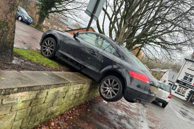 'Can't park there mate': Residents bemused as car left hanging over wall