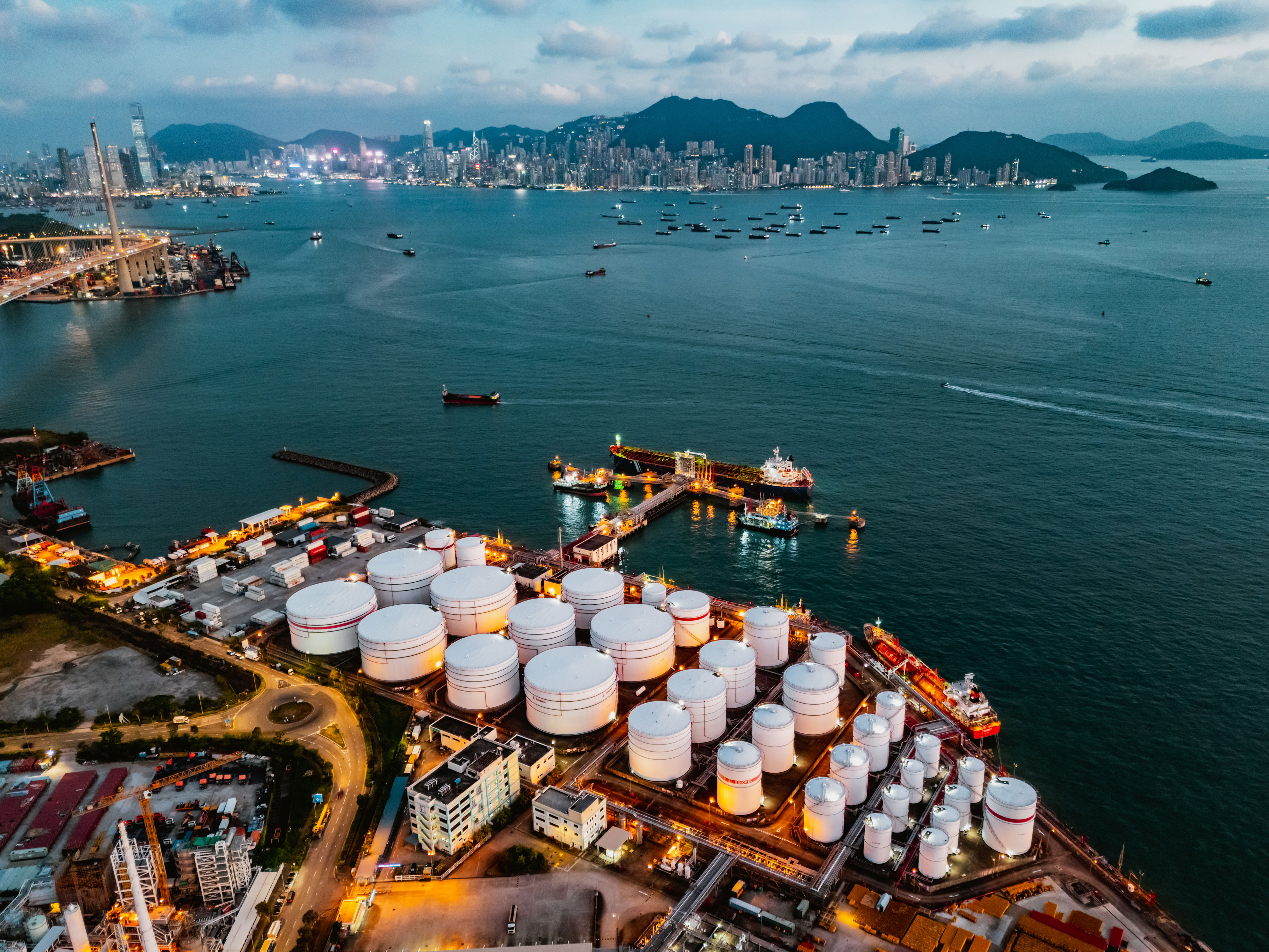 Oil prices fall to 4-year low below $55 as supply glut shows up