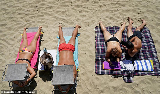Brits sunbathing on Sunny Sands beach in Folkestone, Kent, last July. 2025 was England's sunniest year on record 