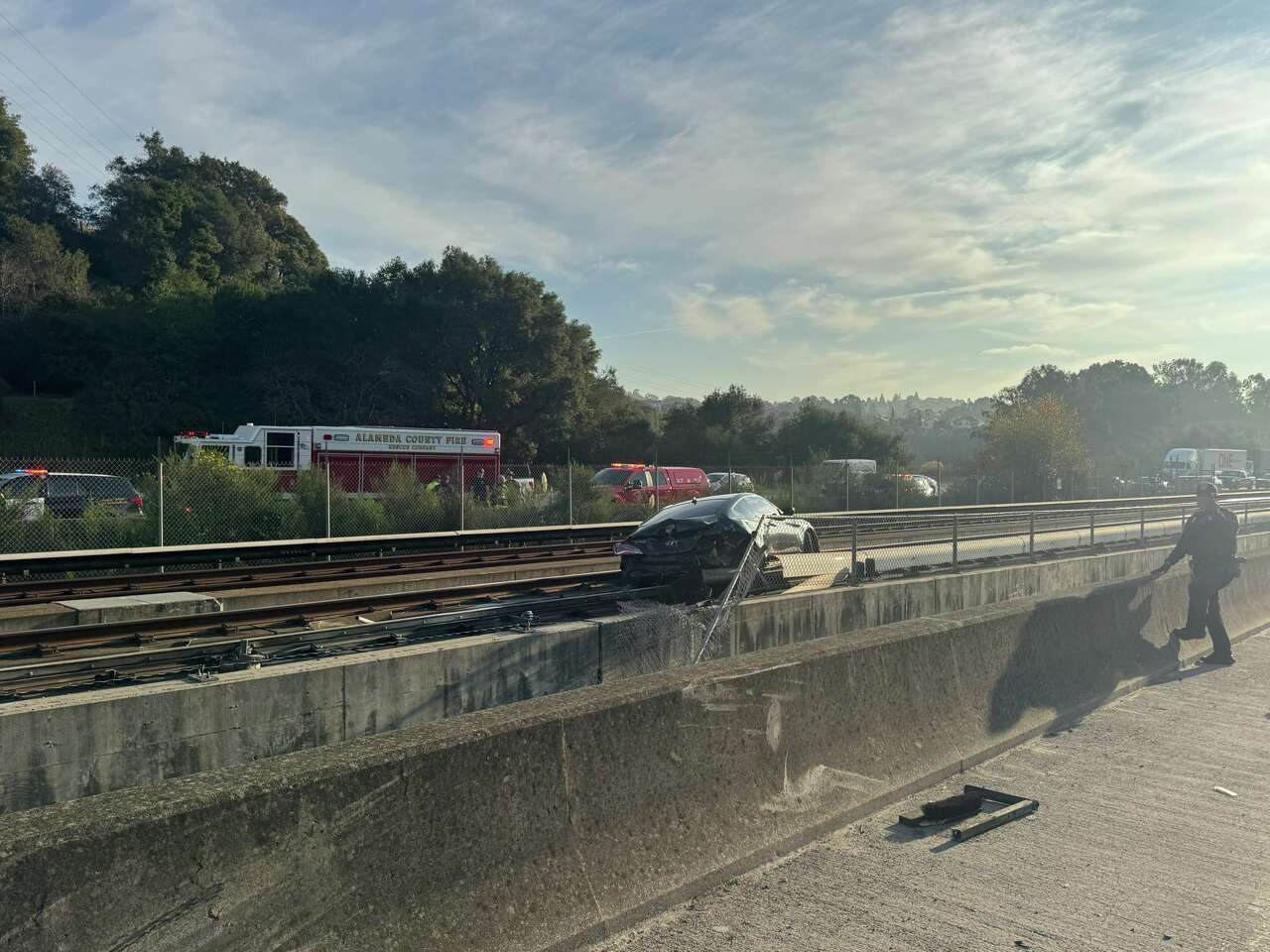 BART service halted after car from freeway crash falls onto the tracks<br><br>