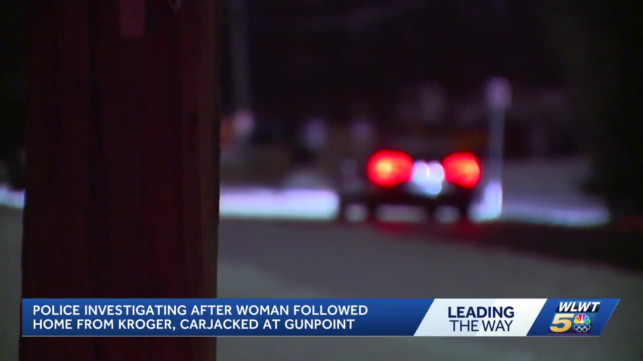 Police investigating after woman followed from store, carjacked at gunpoint