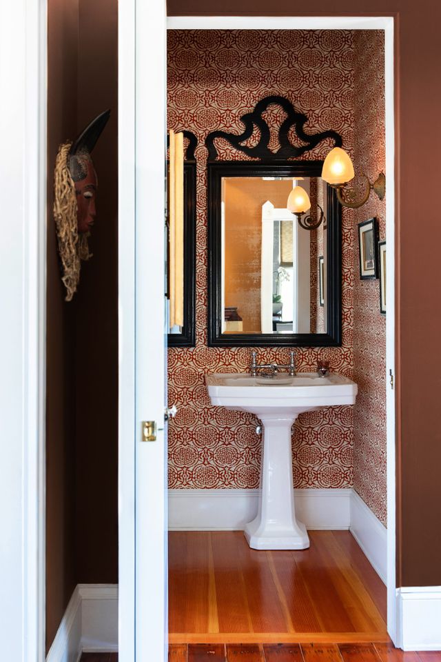 Ornate mirror on patterned wallpaper