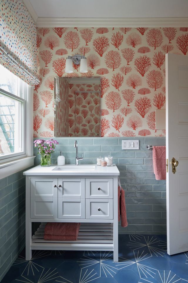 Red and white wallpaper in blue bathroom