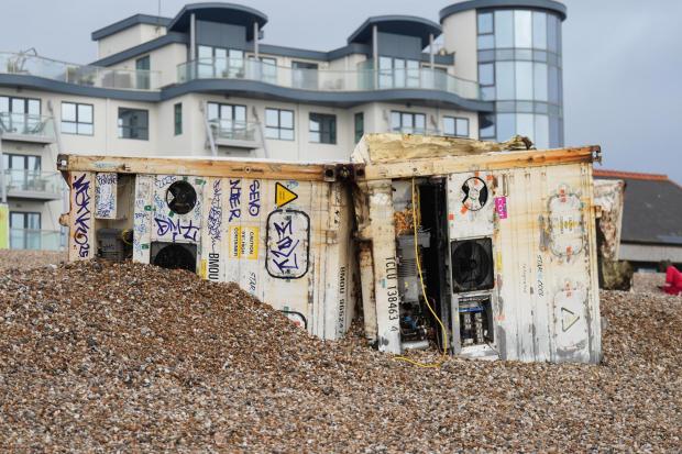 What's happening with massive shipping containers washed up on beaches?