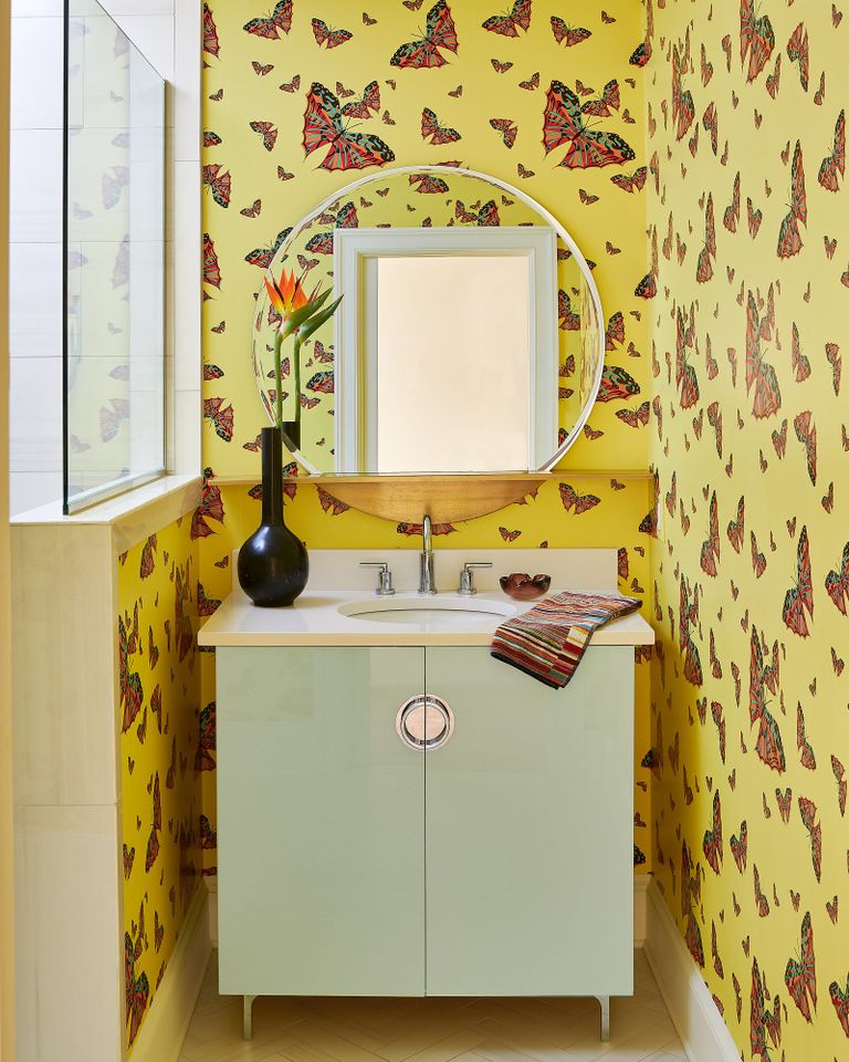 Yellow patterned wallpaper and green sink