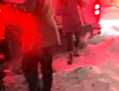 Neighbors work together to dig out bus stuck in snow